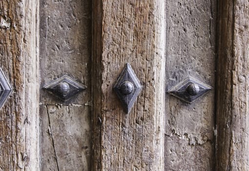 Old medieval wooden door, detail of a textured wooden background