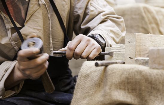 Carving stone, detail of a craftsman, manual work, action