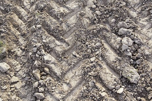 Traces of wheels in the mud, detail of marks in the nature