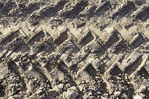 Traces of wheels in the mud, detail of marks in the nature