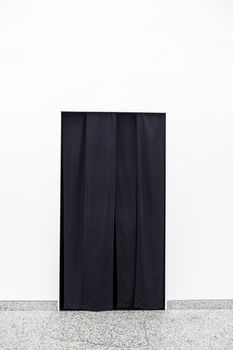 Black curtain on a door, detail of a curtain to separate rooms