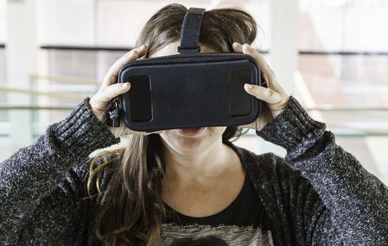 Woman with virtual reality glasses playing, technology and entertainment