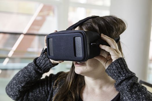 Woman with virtual reality glasses playing, technology and entertainment