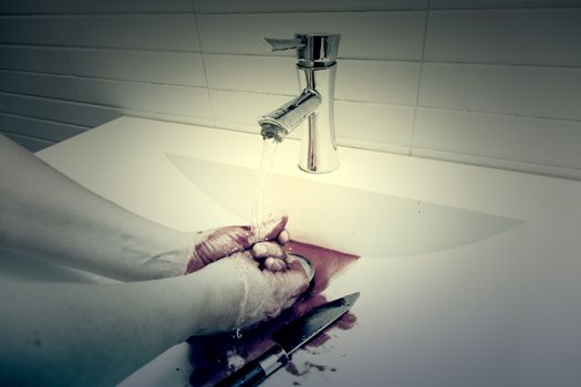 Assassin cleaning the blood, detail of a homicide, blood and death