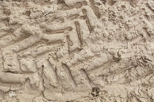 Traces of wheels in the mud, detail of marks in the nature