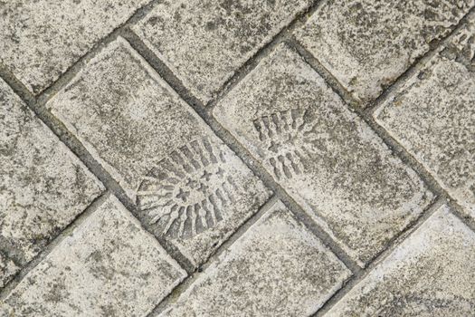 Footprint cement, detail of a sneaker mark, sign
