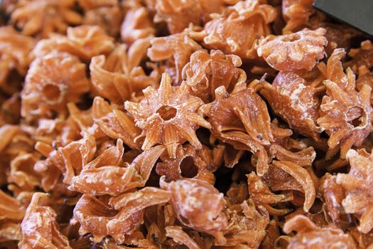 Dry edible hibiscus flower, caramelized flower detail, healthy food