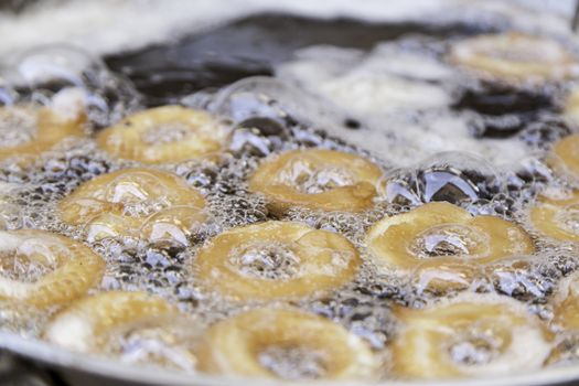 Fried donuts, detail of a traditional market, homemade confectionery