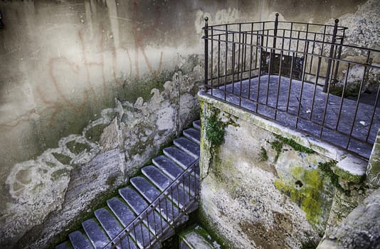Old stone stairs, detail of a pedestrian stairs in the city, dirt and neglect
