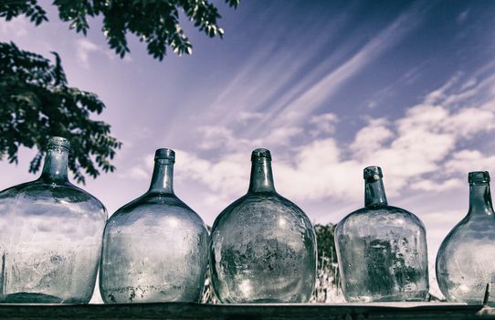 Old glass bottles, detail of some containers to save liquid