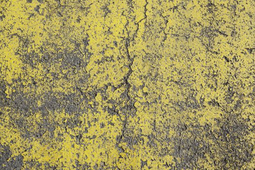 Yellow asphalt damaged, detail of an old and abandoned road