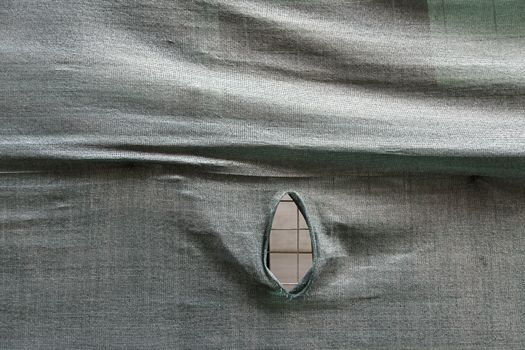 Broken protection fabric, protection and safety detail, textured mud