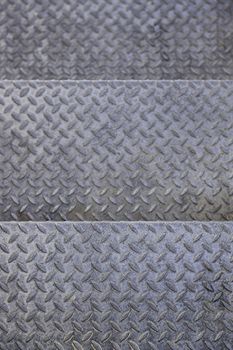 Rough metal background, detail of a non-slip metal, textured background, dirty and damaged metal