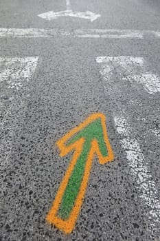 Arrow painted on the asphalt, detail of information and indication, road safety