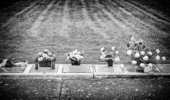 Graves with flowers, detail of an old cemetery, death and religion