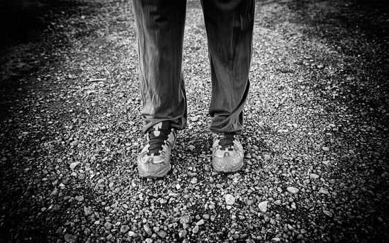 Muddy shoes, detail of a dirty and bedraggled pilgrim