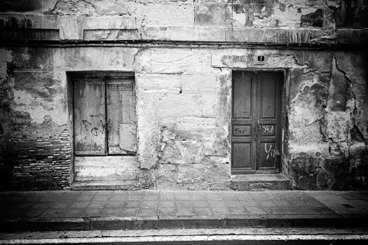 Old wooden door wall, detail of a building in ruins and abandoned