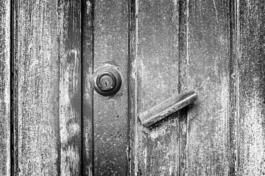 Abandoned rusty metal door detail of an old door, protection