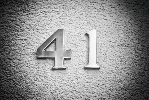 Number forty-one on the wall of a house, detail of an odd number