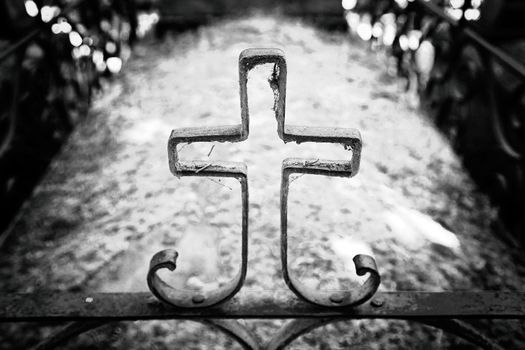Religious cross on a grave, detail of an old cross in a cemetery