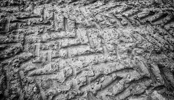 Traces of wheels in the mud, detail of some marks of a vehicle