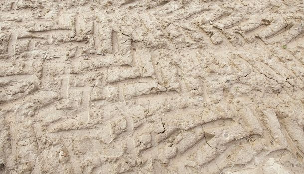 Traces of wheels in the mud, detail of some marks of a vehicle