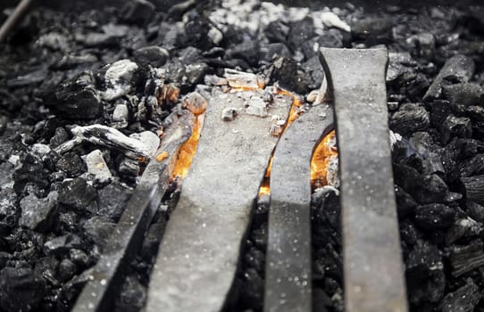 Embers in a forge, detail of an old iron forge, molding iron