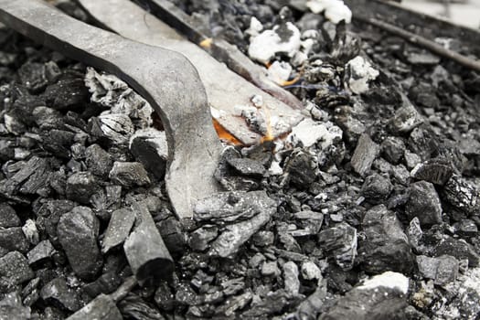 Embers in a forge, detail of an old iron forge, molding iron