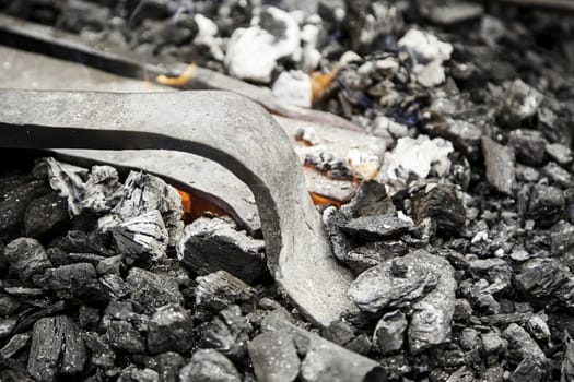 Embers in a forge, detail of an old iron forge, molding iron