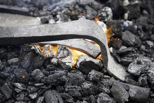 Embers in a forge, detail of an old iron forge, molding iron