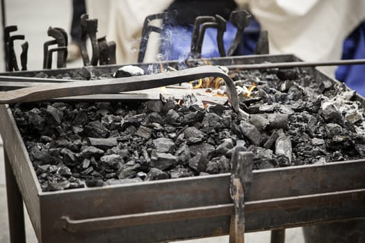 Embers in a forge, detail of an old iron forge, molding iron