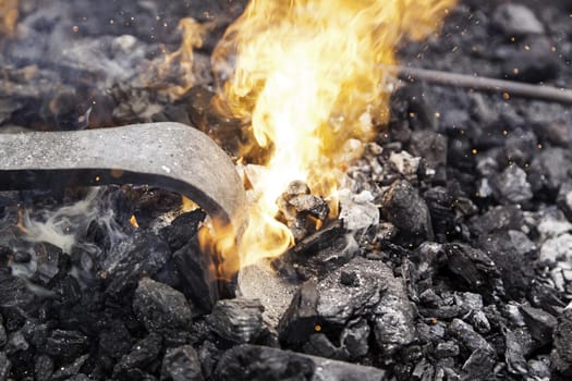 Embers in a forge, detail of an old iron forge, molding iron