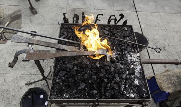 Embers in a forge, detail of an old iron forge, molding iron