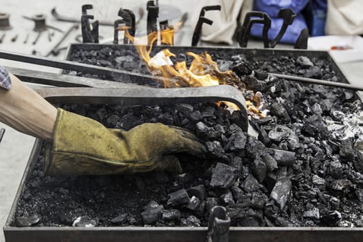Embers in a forge, detail of an old iron forge, molding iron