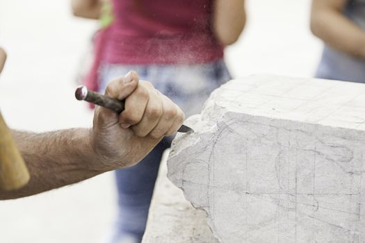 Carving stone, craftsman shaping stone, art and crafts