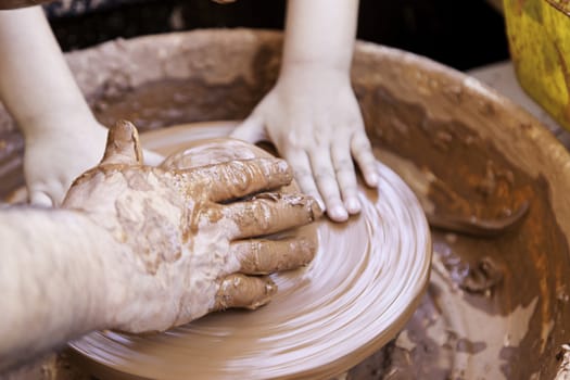 Person working with clay, detail of craftsmanship, craftsmanship in clay, potter