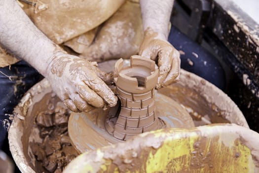 Person working with clay, detail of craftsmanship, craftsmanship in clay, potter