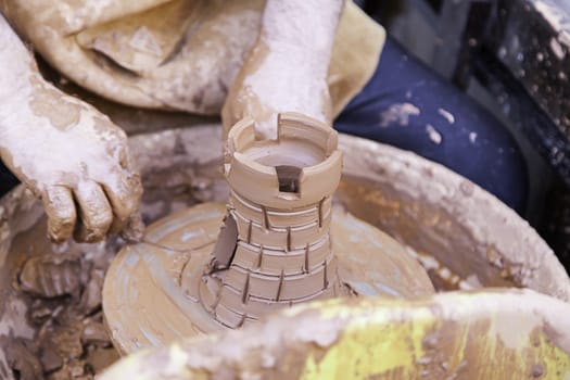 Person working with clay, detail of craftsmanship, craftsmanship in clay, potter