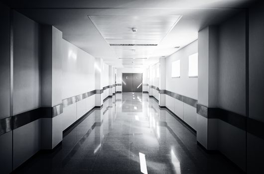 Deep hospital corridor, detail of a white corridor in a hospital, architecture and health