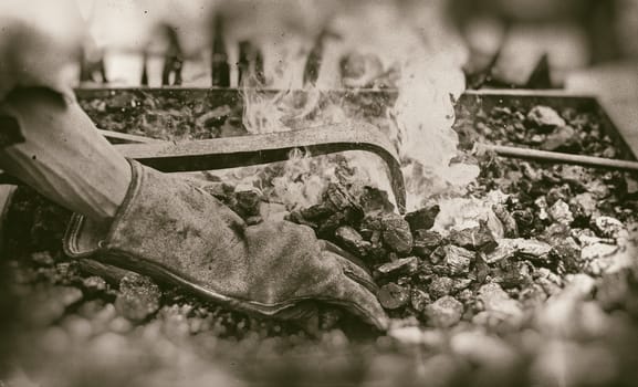 Embers in a forge, detail of an old iron forge, molding iron