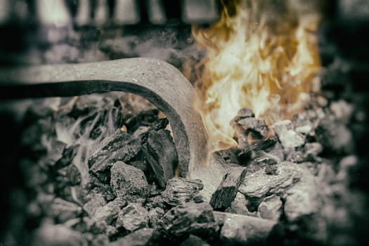Embers in a forge, detail of an old iron forge, molding iron