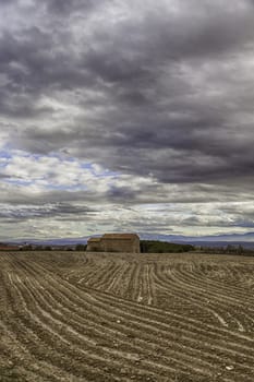 Countryside landscape with house, detail of a plowed field