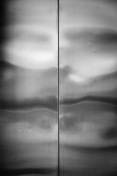 Elevator door, detail of a shiny metallic background