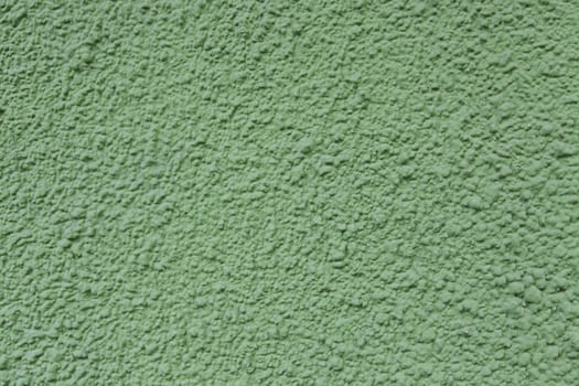 Green wall with texture, detail of a color textured background, decoration and color