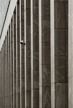 Surveillance camera in columns, detail of a facade in the city, security and precaution, closed circuit