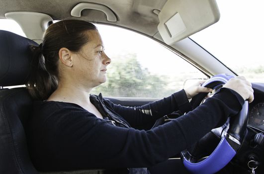 Young woman driving, detail of a modern woman, transportation and fun, speed