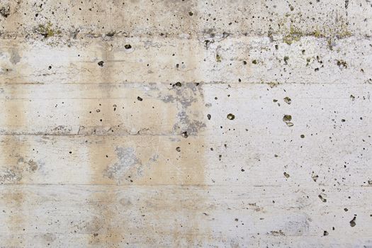 Concrete wall with moisture, detail of erosion and ruin, textured background