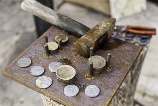 Making handmade coins, handicraft work detail, antiquity