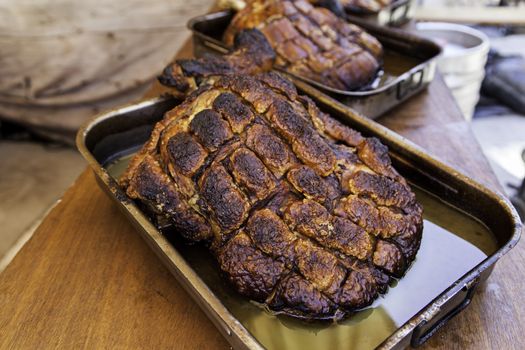 Roasted pork ham in a market