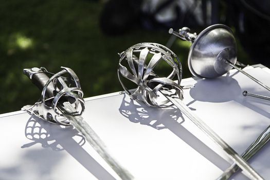 Old medieval swords, detail of old weapon of war, history and death, white weapon